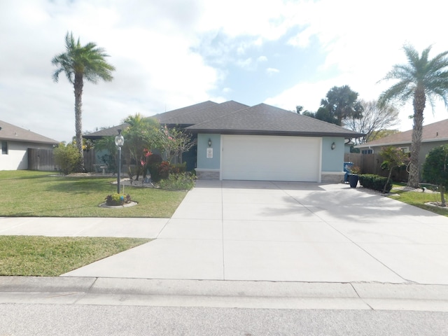 view of front of house featuring a front lawn and a garage