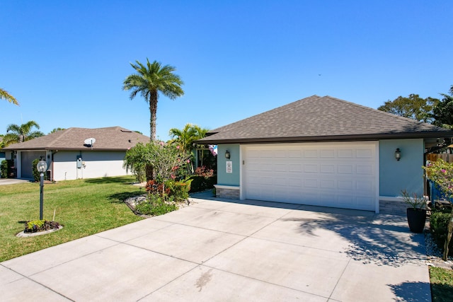 ranch-style house featuring a front lawn and a garage