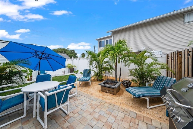 view of patio / terrace with area for grilling and a fire pit