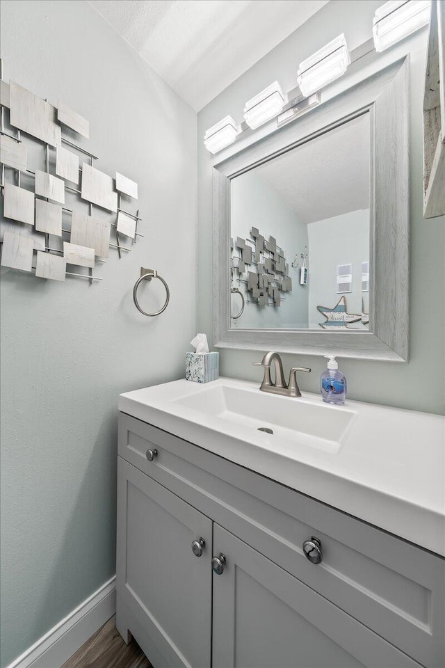 bathroom with hardwood / wood-style floors and vanity