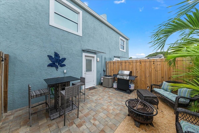 view of patio / terrace featuring area for grilling and an outdoor living space with a fire pit