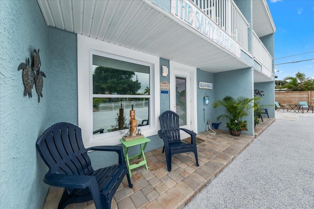 view of patio featuring a balcony