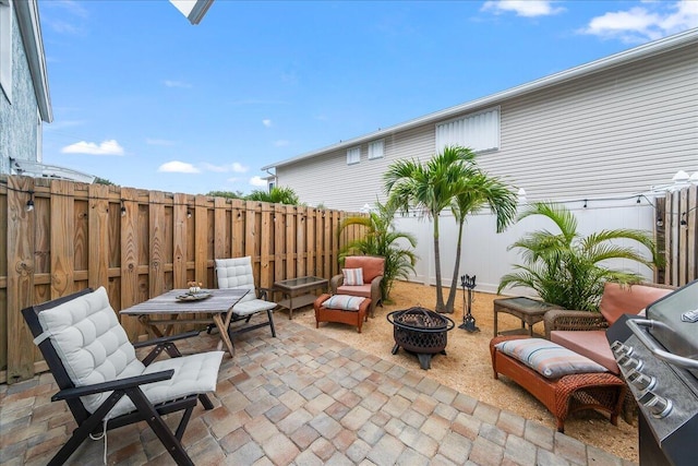 view of patio with a grill and an outdoor fire pit