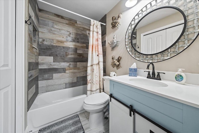 full bathroom featuring tile patterned flooring, shower / bath combo with shower curtain, vanity, and toilet