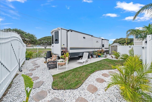 view of yard featuring a patio and an outdoor fire pit