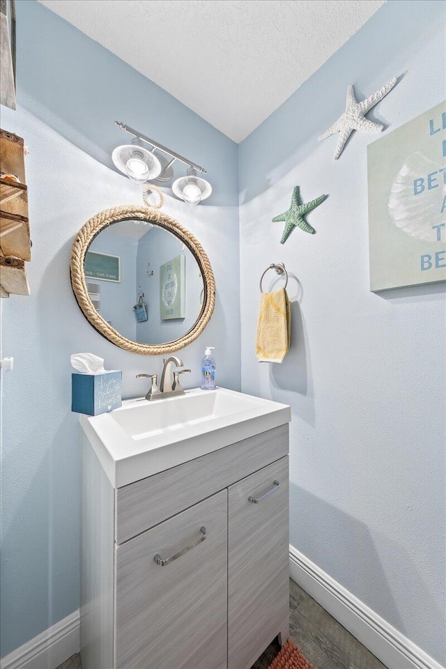 bathroom with vanity and a textured ceiling