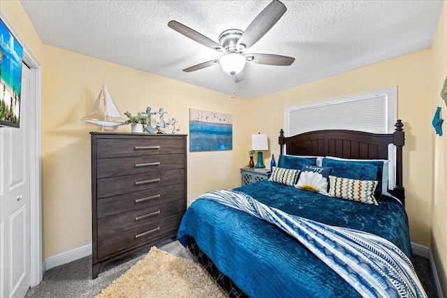 bedroom with ceiling fan, light colored carpet, and a textured ceiling