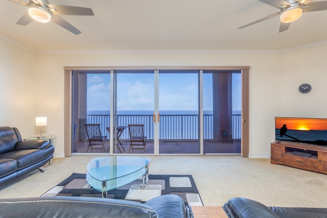 living room with ornamental molding, ceiling fan, and a water view