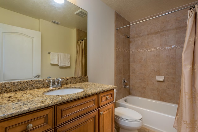 full bathroom with shower / tub combo, a textured ceiling, oversized vanity, and toilet