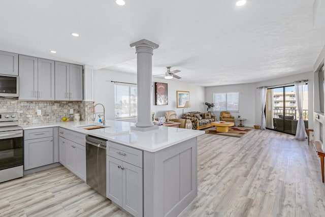 kitchen featuring stainless steel appliances, ceiling fan, gray cabinets, and sink