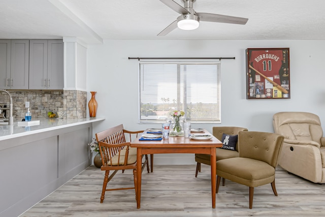 dining area featuring ceiling fan and light wood-type flooring