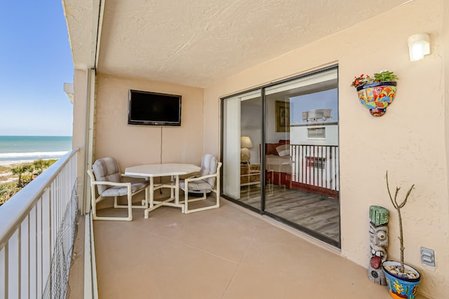 balcony featuring a water view