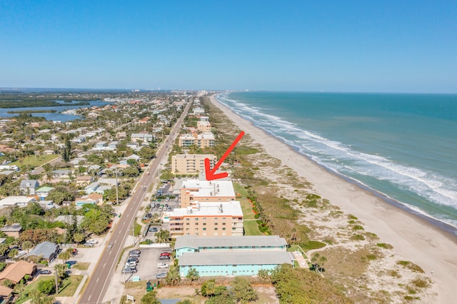 drone / aerial view featuring a beach view and a water view