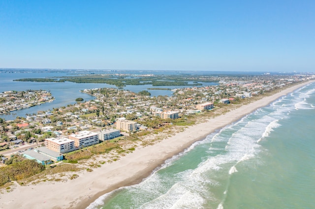 bird's eye view featuring a water view and a view of the beach