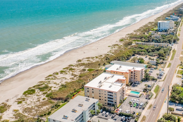 birds eye view of property with a view of the beach and a water view