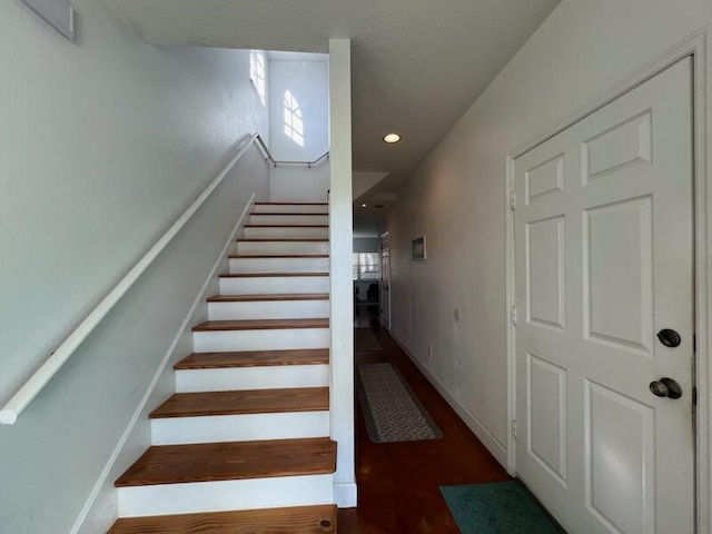 stairway featuring dark wood-type flooring