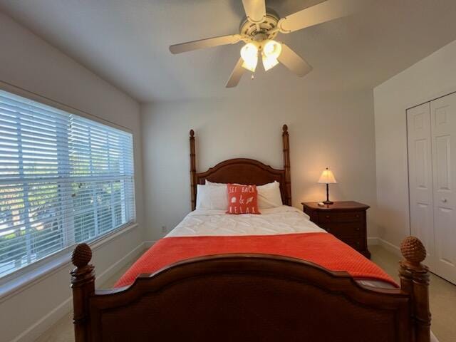 carpeted bedroom featuring a closet and ceiling fan