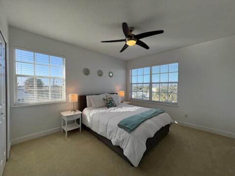 carpeted bedroom with ceiling fan