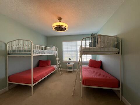 carpeted bedroom with a textured ceiling