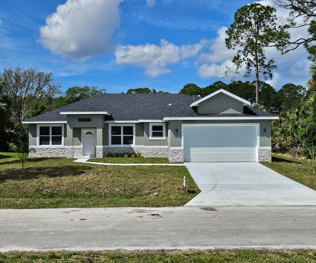 view of front of home with a front yard and a garage