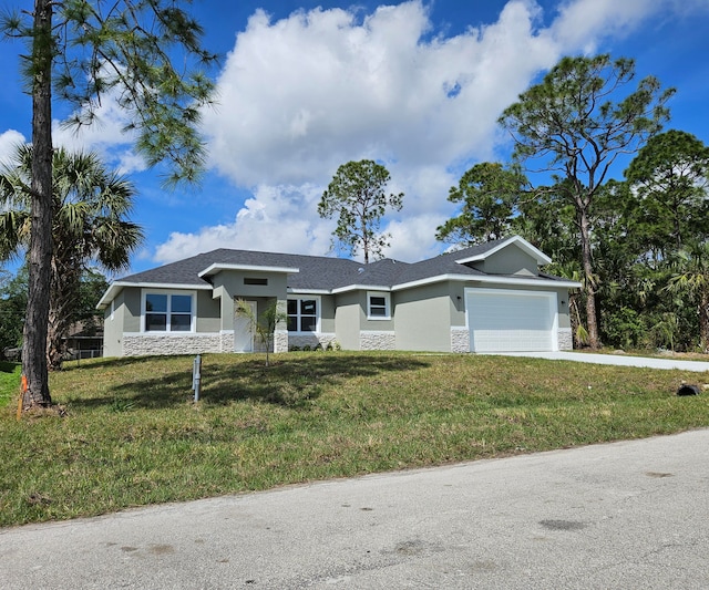 single story home featuring a front yard and a garage