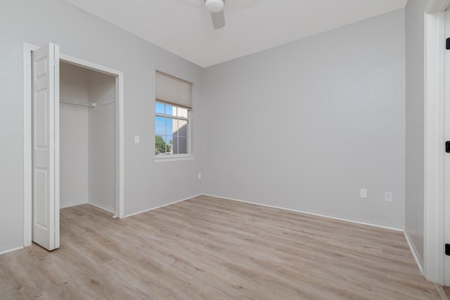 unfurnished bedroom with a closet, light hardwood / wood-style floors, and ceiling fan