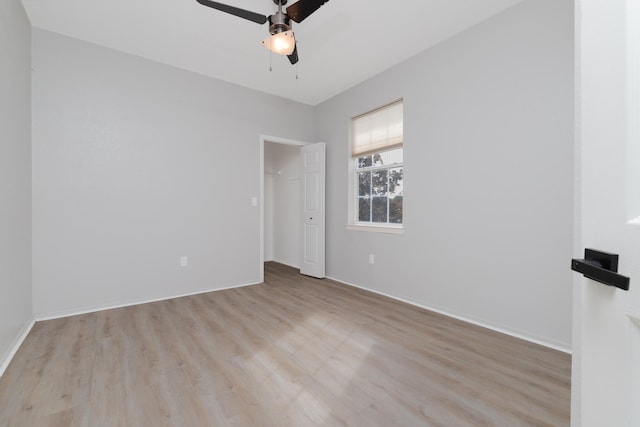 spare room featuring ceiling fan and light wood-type flooring