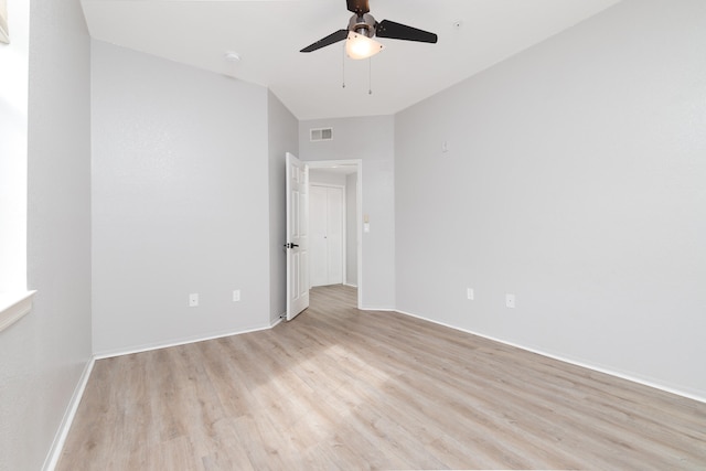 empty room with ceiling fan and light hardwood / wood-style flooring