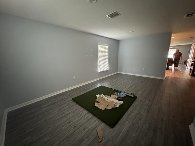 empty room with dark wood-type flooring