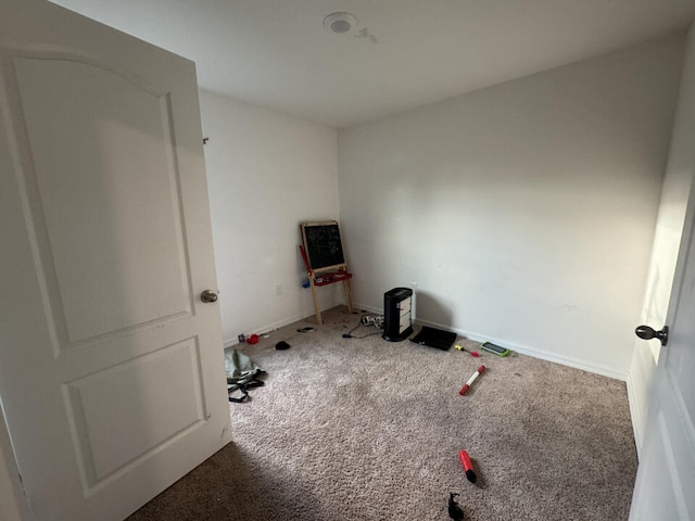 workout room featuring dark colored carpet