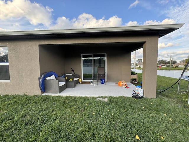 back of house with a patio area and a yard