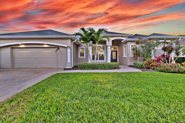 view of front facade with a lawn and a garage