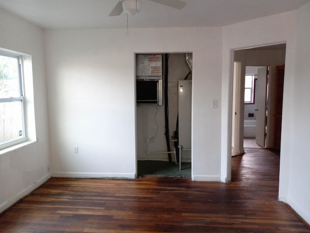 spare room featuring ceiling fan and dark wood-type flooring