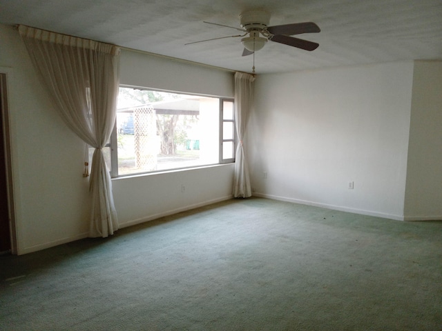 carpeted empty room with ceiling fan