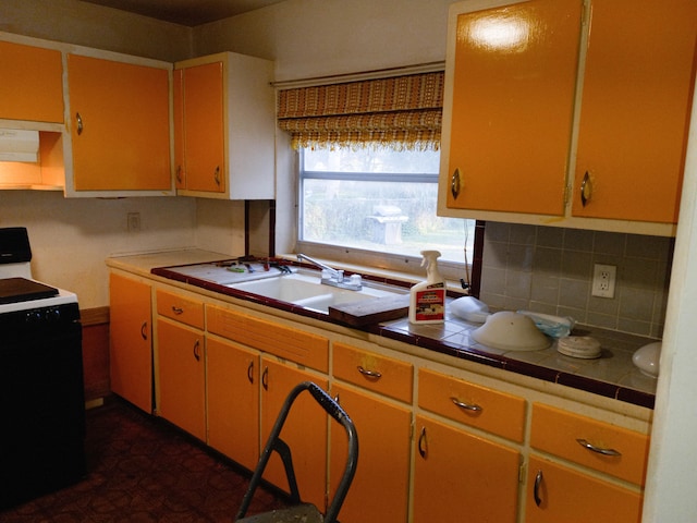 kitchen featuring backsplash, white range with electric stovetop, tile counters, and sink