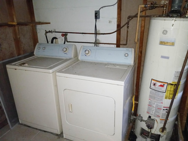 laundry area featuring water heater and separate washer and dryer