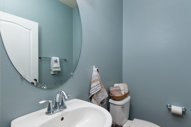 bathroom featuring toilet and sink