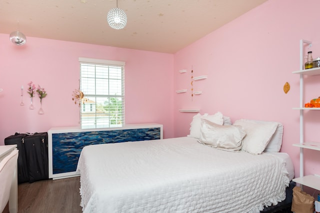 bedroom with dark hardwood / wood-style floors