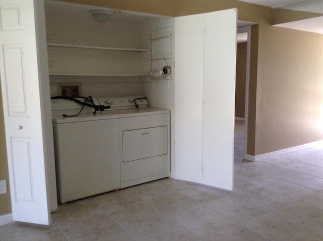 laundry area featuring washer hookup, separate washer and dryer, and light tile flooring