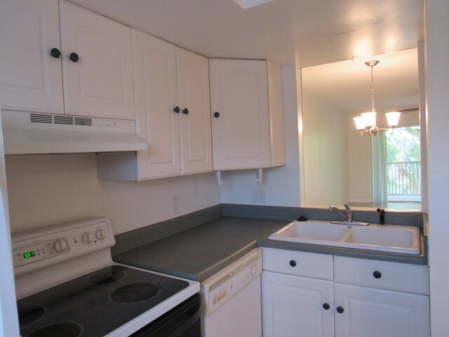 kitchen featuring a chandelier, dishwasher, stove, and white cabinetry