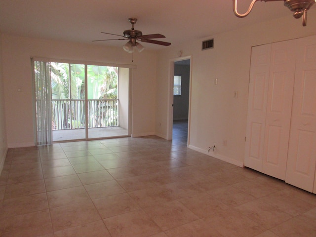 spare room with light tile floors and ceiling fan