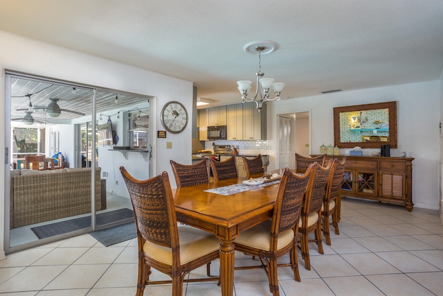 dining area featuring a chandelier and light tile patterned floors