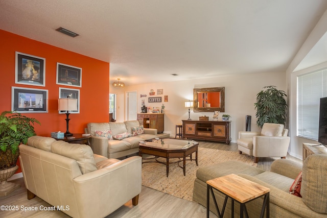 living room with light hardwood / wood-style flooring