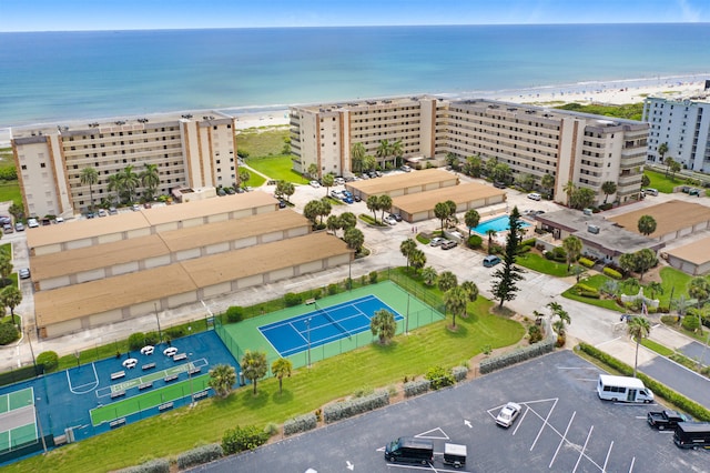 drone / aerial view with a beach view and a water view