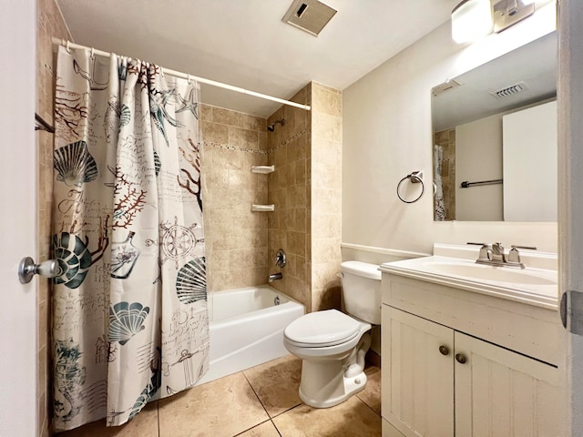 bathroom featuring toilet, vanity, visible vents, tile patterned floors, and shower / bath combo