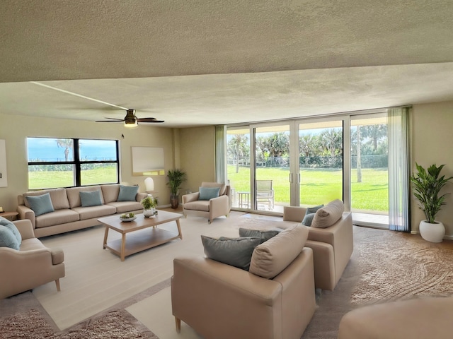 living room featuring a textured ceiling, french doors, and a ceiling fan