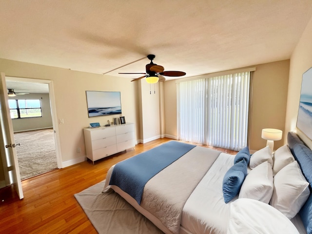 bedroom featuring light wood-type flooring and ceiling fan