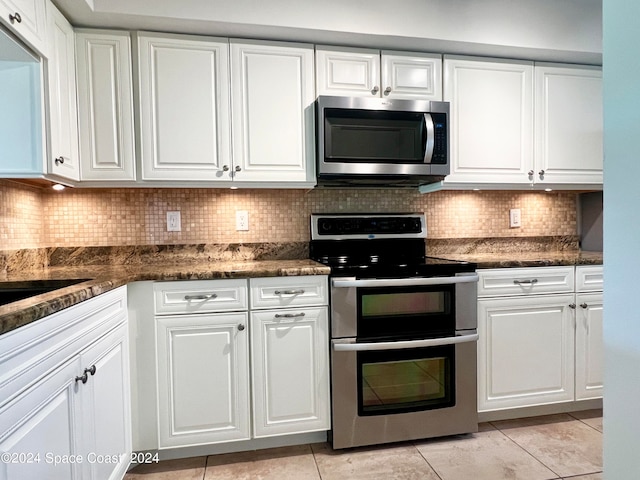 kitchen with white cabinets, decorative backsplash, and appliances with stainless steel finishes