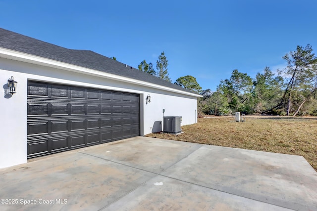 view of side of property featuring cooling unit and a garage