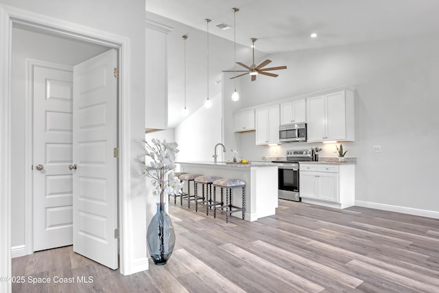 kitchen featuring light wood finished floors, appliances with stainless steel finishes, visible vents, and white cabinets